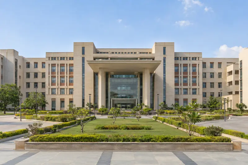 Completed institutional campus building with a landscaped forecourt